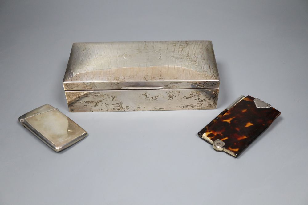 A silver mounted cigarette box. 19.5cm, a silver card case and a tortoiseshell and ivory aide memoir.